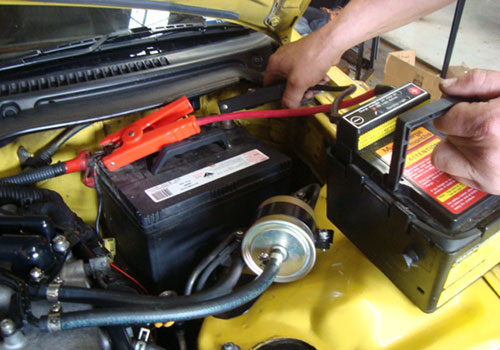 automotive technician checking battery